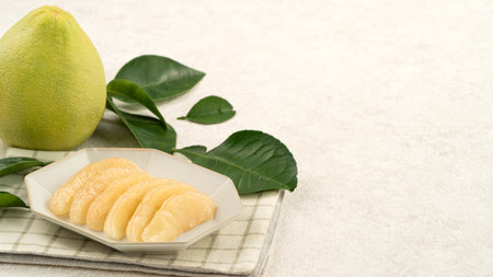 Fresh peeled pomelo with leaf on white table background for Mid-Autumn Festival fruit.