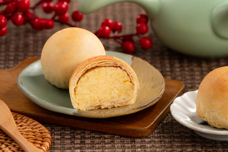 Round Taiwanese small mung bean pastry with golden flaky crust and sweet filling for moon festival.