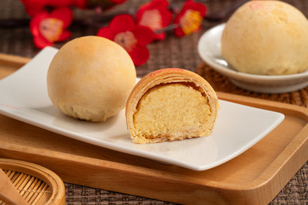 Round Taiwanese small mung bean pastry with golden flaky crust and sweet filling for moon festival.