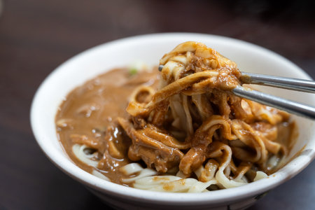Bowl of noodles covered in rich thick sesame sauce, traditional Taiwanese food.の写真素材