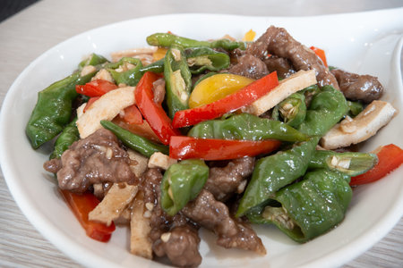A flavorful stir-fried beef dish featuring aromatic colorful peppers.の写真素材