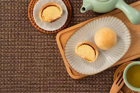 Round Taiwanese small mung bean pastry with golden flaky crust and sweet filling for moon festival.