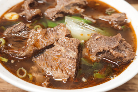 Taiwanese beef noodle soup with rich broth, famous food with sliced red braised beef and vegetables...