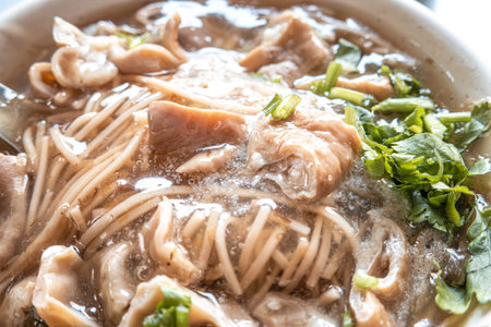 Homemade delicious thin vermicelli noodles in a bowl on dark wooden table background.