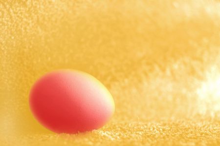 pink egg on the yellow backgroundの写真素材