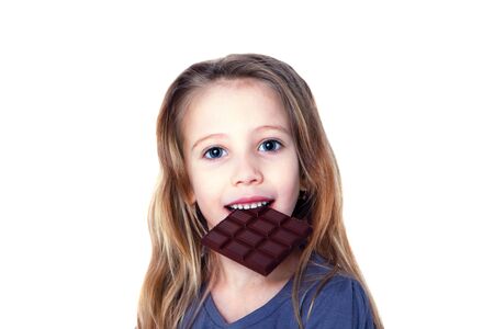 Smiling girl eating chocolate isolated on whiteの写真素材