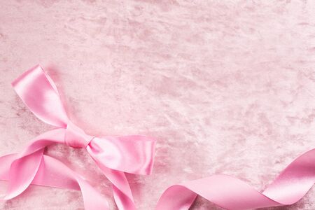 Silky satin plush pink backround with atlas bow and ribbonの写真素材