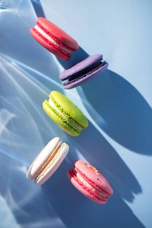 Cakes macaroon or macaron on blue background, close upの写真素材
