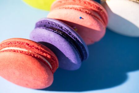 Colorful cakes macaroon or macaron on blue background, close upの写真素材