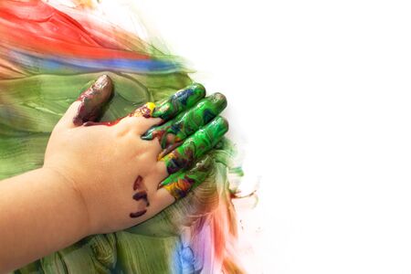 Kids hand with finger paint and colorful fragments isolated on whiteの写真素材