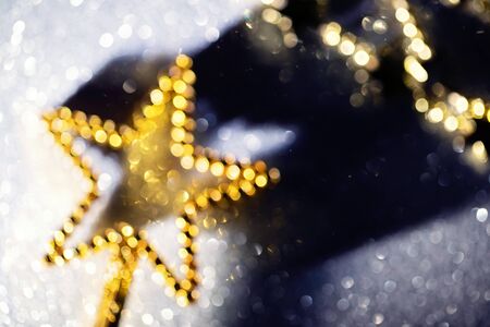 Golden star with bokeh effect, festive christmas backgroundの写真素材
