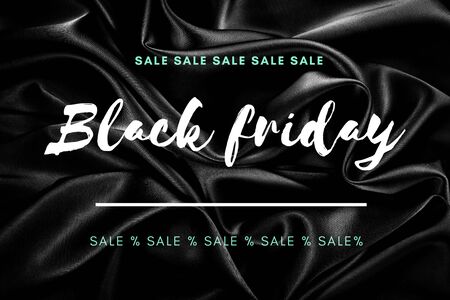 Black friday sale text on black wavy textile background, bannerの写真素材