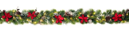 Christmas tree garland decorated with red christmas poinsettia flowers and shiny led lights, festive bannerの写真素材