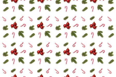 Christmas red balls with spruce branches and canes, seamless pattern on whiteの写真素材