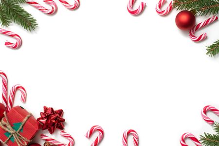 Christmas frame background with canes, spruce branches and red balls on white, greeting card templateの写真素材