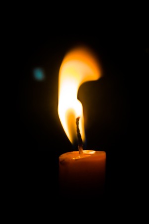 Disturbed flame of a candleの写真素材