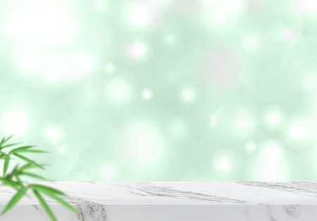 Empty marble table with leaves and green bokeh background for product backdrop with copy space for advertising text, luxury studio stageの写真素材