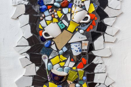 Colorful ceramic mosaic floor or wall. Creative recycled idea. Modern bathroom or kitchen floor design idea. Reused broken tile. Contemporary interior or outdoors design. Colored eastern potteryの写真素材