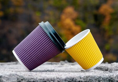 Concept of reliance, friendship, support, relations, male female, A pair of brown yellow paper cups, take out, coffee to go. Two eco-friendly heat proof cardboard mugs, close upの写真素材