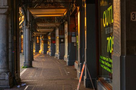 AMSTERDAM, NETHERLANDS - April 2, 2019: close-up part of streets shops illuminated golden sunrise light.のeditorial素材