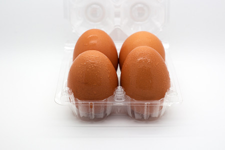 Four eggs in open transparent packageの写真素材