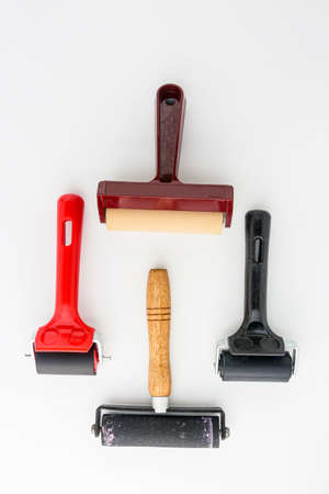 Collection of rubber brayers use in craft process on white background in top view.の写真素材