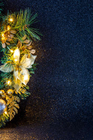 Sparkle and glittering Christmas wreath with silver balls, gold leaves on dark blue background.の写真素材