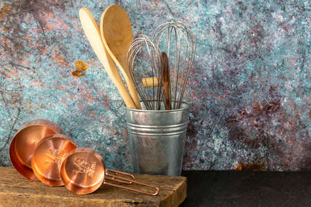 Vintage kitchen concept, set of measuring cups lay on old natural wood board in horizontal view with copy spaceの写真素材