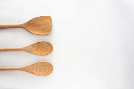 Wooden kitchen tools, spoon  and spatula, top view shot on white background.の写真素材