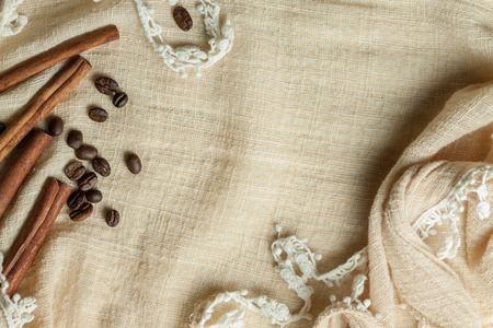 cinnamon and coffee beans on flax textureの写真素材