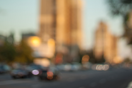 Blurred background photo.Cityscape bokeh. Defocused abstract city.Background out of focus.Can use as wallpaper, design. Summer blurry city backdrop.Travel out of focus photos. Fairy defocused photos.の写真素材