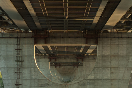 Under the bridge. Industrial wallpaper. Perspective. Symmetry. Concrete structuresの写真素材