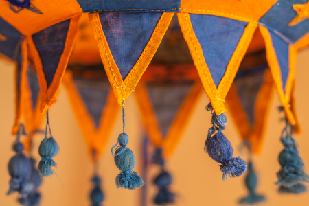 cozy lampshades. woven hand made lampshade close-up. blurry background. relax bedroom wallpaper. warm light. embroidered stars. ethnic ornamentの写真素材