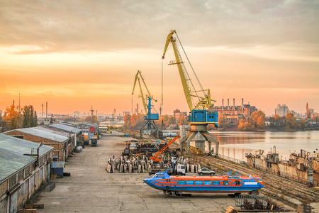 Harbor cranes at sunsetの写真素材