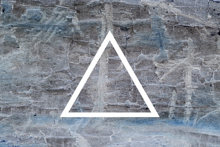 White flat triangle on abstract stone background. Abstract psychedelic background.の写真素材