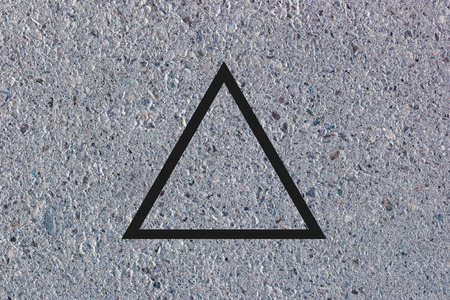 Black flat triangle on abstract concrete background. Abstract psychedelic background.の写真素材