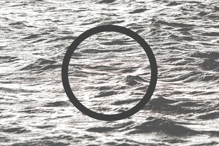Black flat circle on abstract water background. Abstract psychedelic background.の写真素材