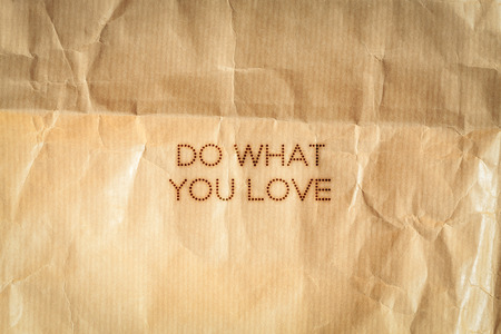 Do what you love. Inspiration card on crumpled paper background.の写真素材