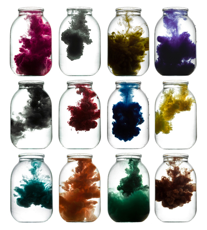 Paint swirling in water. Colorful smoke a glass jar.の写真素材