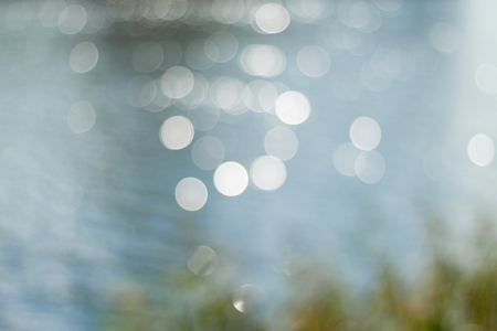 Solar patches of light on water. Abstract blurry nature backgroundの写真素材