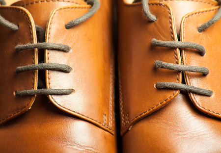 Men's leather shoes on a wooden floorの写真素材