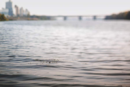 Blurry cityscape. Waves in Contre-jour. Natural optical tilt shift photo.