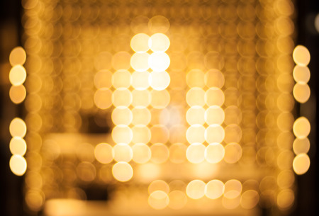 Golden lightbulbs. Abstract defocused background.の写真素材