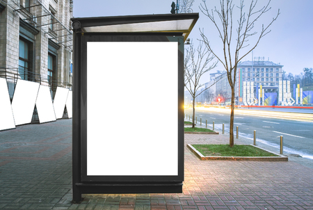 Vertical blank glowing billboard on the bus stop. Street outdoor advertising.の写真素材