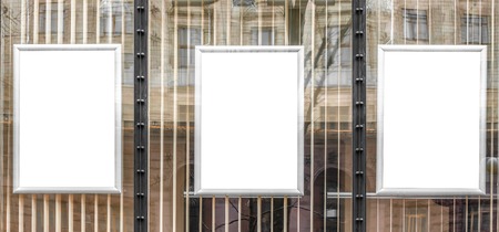 Blank white posters in aluminium frames. Glassy showcase on the street. Background for mockupの写真素材
