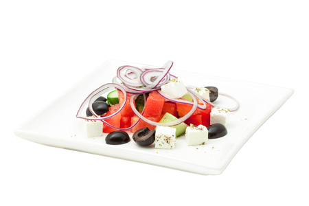 Salad with vegetables and cheese on square plateの写真素材