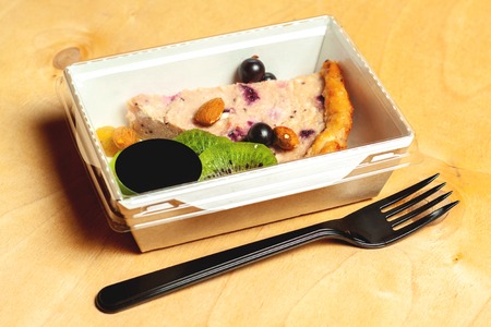 Cheesecake with blueberries, almond, raisins and sliced kiwiの写真素材