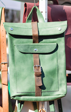 Green leather backpack in the bright midday sunの写真素材