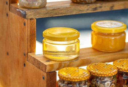 Natural honey in jars on the counter. Autumn Fair