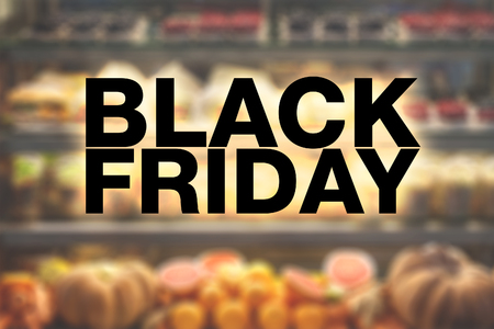 Black friday poster. Blurry showcase with salads, sandwiches and vegetables on backgroundの写真素材